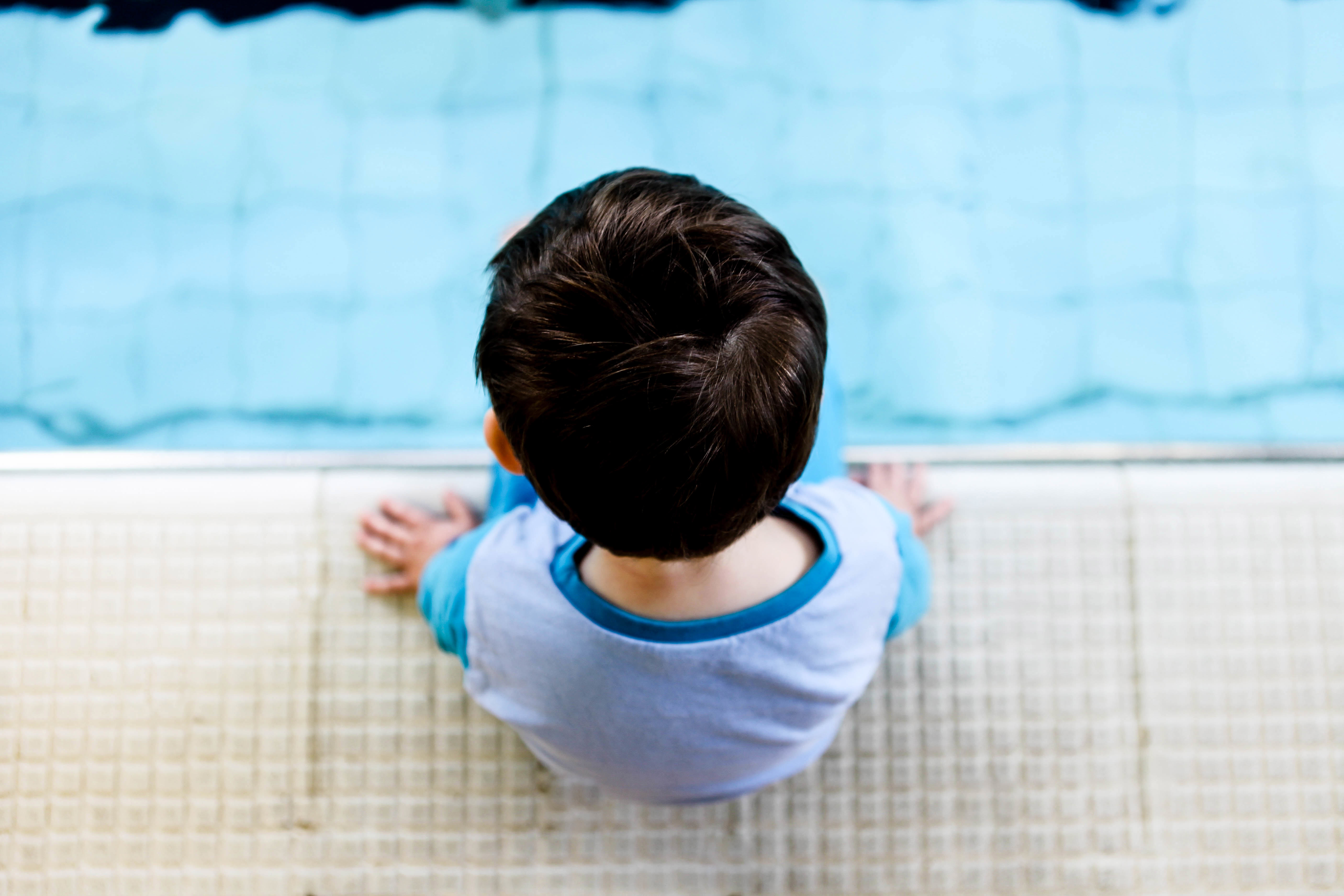 Pre-School Swimming Lessons (Child Sitting Poolside)