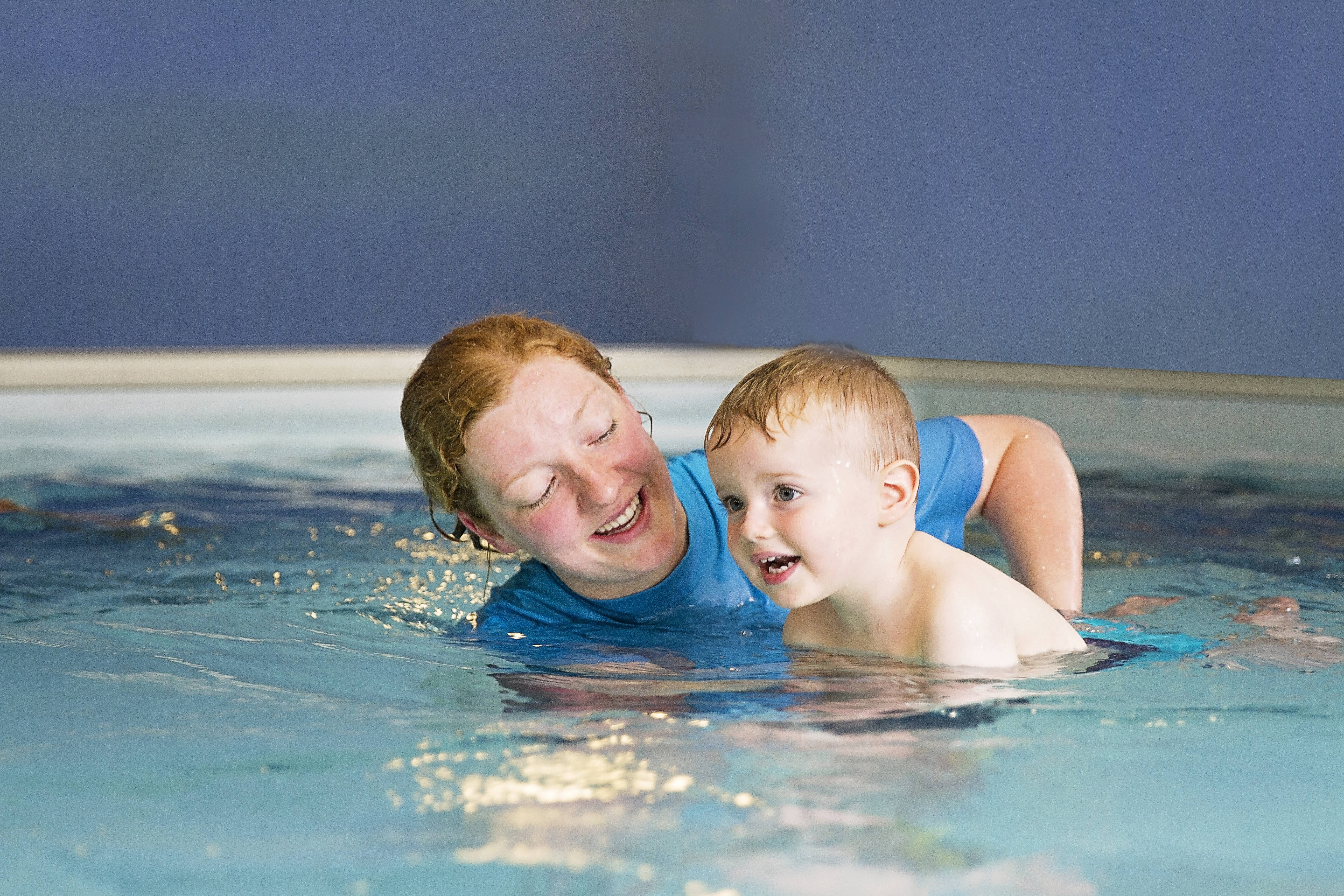 splashers teacher smiling at baby